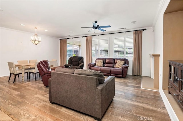 26865 Shelter Cove Ct, Menifee, CA 92585 - living area with crown molding, ceiling fan, light wood-type flooring, a chandelier, and recessed lighting