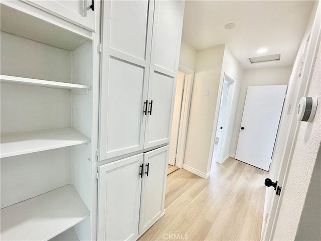 1439 Sheridan Rd, San Bernardino, CA 92407 - hallway featuring light wood finished floors and attic access