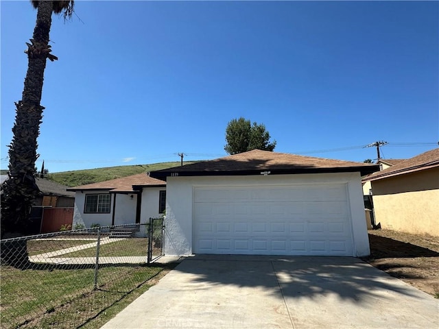 1439 Sheridan Rd, San Bernardino, CA 92407 - ranch-style house with stucco siding, concrete driveway, and a garage