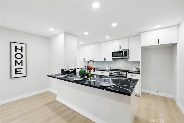 6304 Pablo Ct, Chino, CA 91710 - kitchen with stainless steel appliances, dark countertops, light wood-type flooring, backsplash, and recessed lighting