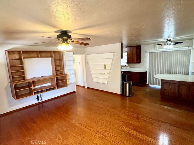 9856 Hawthorne Ave, Hesperia, CA 92345 - unfurnished living room with a ceiling fan, dark wood-type flooring, and a textured ceiling