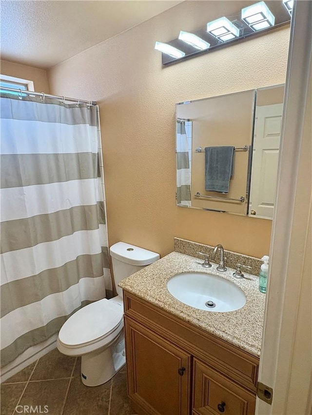 9856 Hawthorne Ave, Hesperia, CA 92345 - bathroom featuring vanity, a textured ceiling, tile patterned flooring, a textured wall, and a shower with curtain