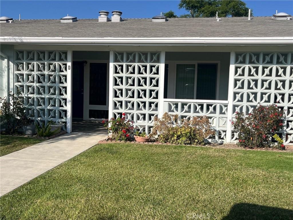 13821 Fresh Meadow Ln Unit M3-D, Seal Beach, CA 90740 - property entrance with a lawn, a porch, and roof with shingles