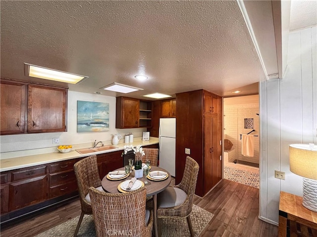 13821 Fresh Meadow Ln Unit M3-D, Seal Beach, CA 90740 - kitchen featuring freestanding refrigerator, a textured ceiling, dark wood finished floors, light countertops, and open shelves