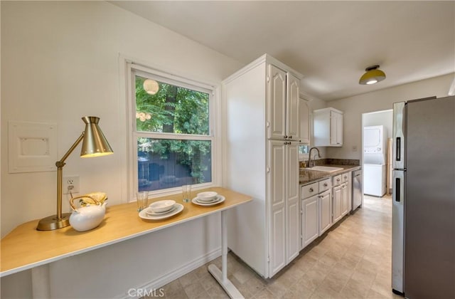 252 E Scenic Dr, Monrovia, CA 91016 - kitchen featuring appliances with stainless steel finishes, estacked washer and dryer, and white cabinetry