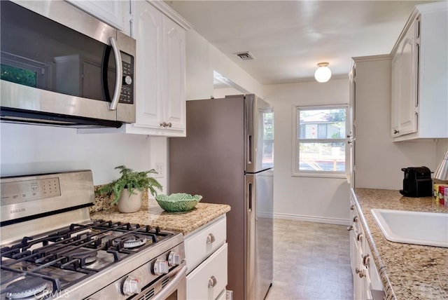 252 E Scenic Dr, Monrovia, CA 91016 - kitchen with appliances with stainless steel finishes, white cabinets, and light stone counters