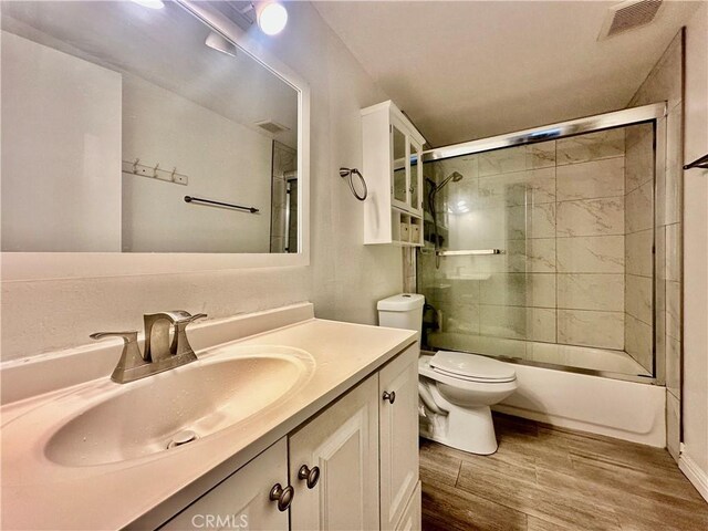 17105 Holmes Cir, Cerritos, CA 90703 - bathroom featuring wood finished floors, vanity, and bath / shower combo with glass door