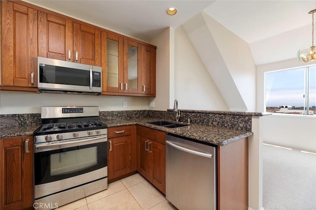 54 Los Cabos, Dana Point, CA 92629 - kitchen with stainless steel appliances, brown cabinets, dark stone counters, a peninsula, and lofted ceiling