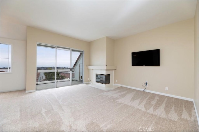 54 Los Cabos, Dana Point, CA 92629 - unfurnished living room featuring plenty of natural light, carpet flooring, and a fireplace with flush hearth