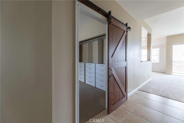 54 Los Cabos, Dana Point, CA 92629 - corridor with light colored carpet, a barn door, and light tile patterned flooring