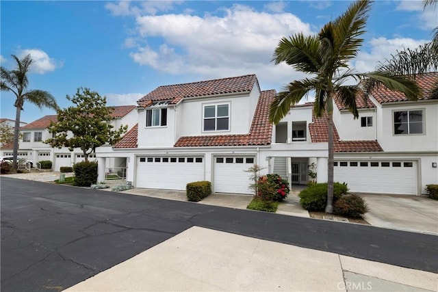 54 Los Cabos, Dana Point, CA 92629 - mediterranean / spanish-style home featuring an attached garage, driveway, a tile roof, and stucco siding