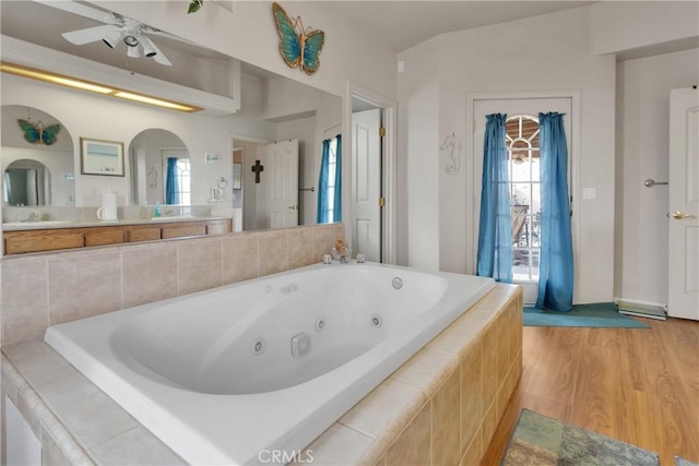 10776 Joshua St, Oak Hills, CA 92344 - bathroom featuring a jetted tub, wood finished floors, and ceiling fan