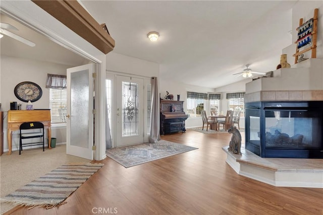 10776 Joshua St, Oak Hills, CA 92344 - foyer entrance featuring a ceiling fan, wood finished floors, vaulted ceiling, and a multi sided fireplace