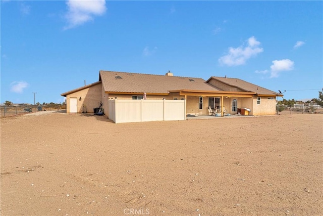 10776 Joshua St, Oak Hills, CA 92344 - back of property with stucco siding and a chimney