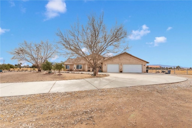 10776 Joshua St, Oak Hills, CA 92344 - view of front facade with an attached garage, driveway, and stucco siding