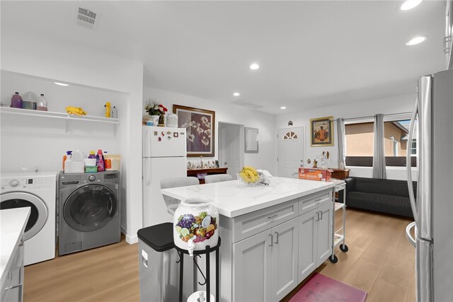3032 Cogswell Rd, El Monte, CA 91732 - kitchen featuring freestanding refrigerator, independent washer and dryer, light wood-style floors, a center island, and recessed lighting