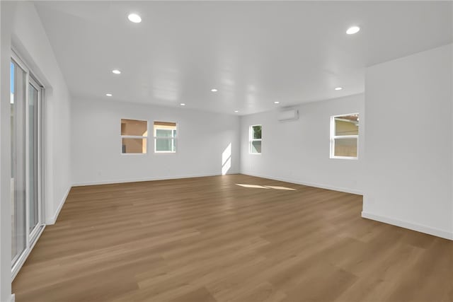 3032 Cogswell Rd, El Monte, CA 91732 - spare room featuring an AC wall unit, light wood-type flooring, and recessed lighting
