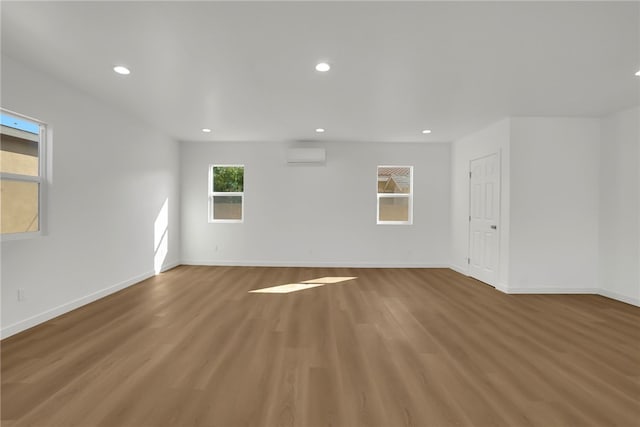 3032 Cogswell Rd, El Monte, CA 91732 - unfurnished room featuring a wall mounted AC, recessed lighting, and light wood-style floors