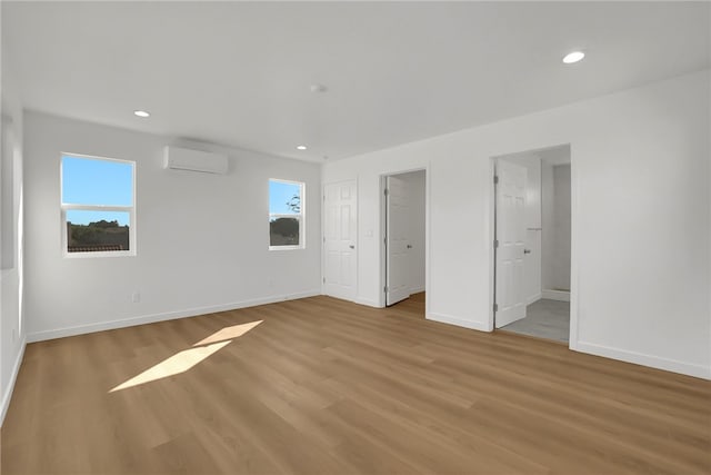 3032 Cogswell Rd, El Monte, CA 91732 - unfurnished bedroom featuring a wall unit AC, light wood-style floors, and recessed lighting