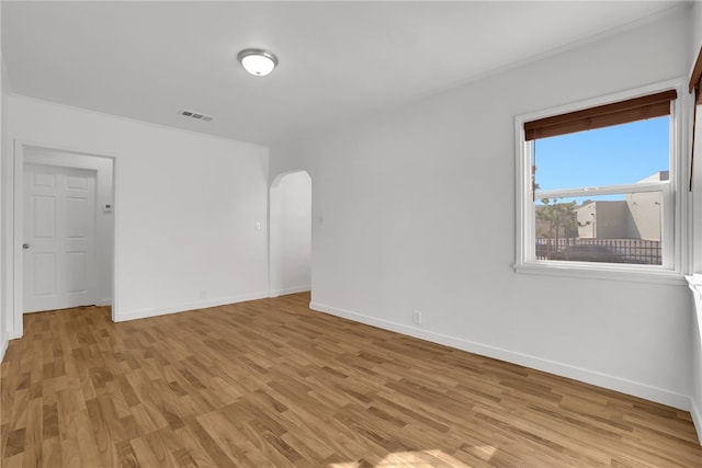 3032 Cogswell Rd, El Monte, CA 91732 - unfurnished room with arched walkways, light wood-style floors, and crown molding