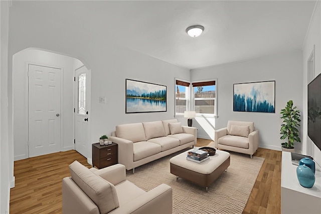 3032 Cogswell Rd, El Monte, CA 91732 - living room featuring light wood finished floors and arched walkways