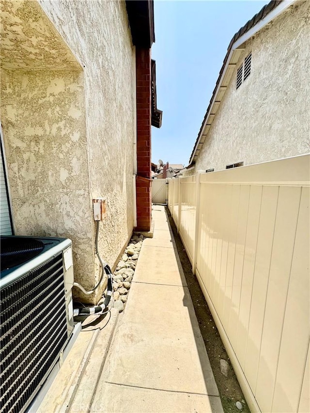 11308 Sherwood Ct, Fontana, CA 92337 - view of side of property featuring stucco siding and a central AC unit