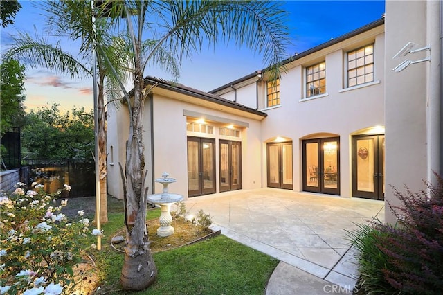 1109 Englemann Ct, Arcadia, CA 91006 - back of house at dusk with french doors, a patio, and stucco siding