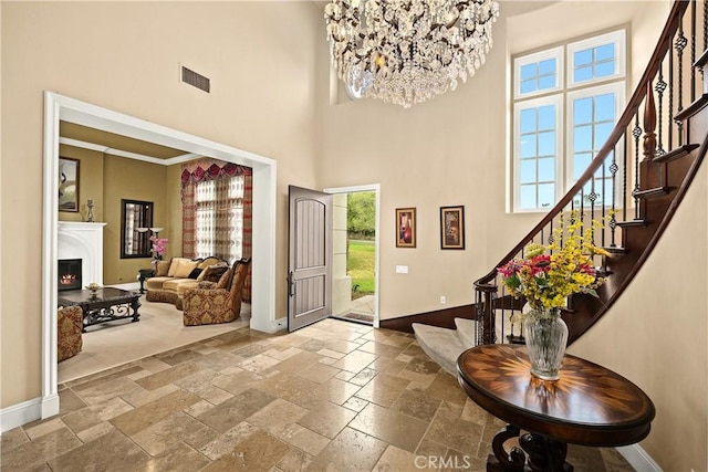 1109 Englemann Ct, Arcadia, CA 91006 - entryway with a towering ceiling, stone tile flooring, stairs, a warm lit fireplace, and a chandelier