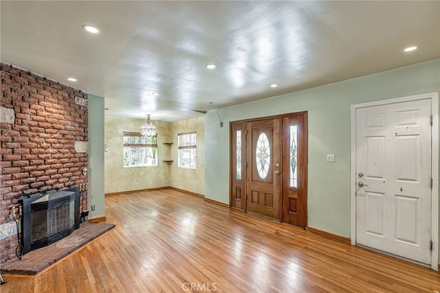 7134 Stansbury Ave, Van Nuys, CA 91405 - foyer with heating unit, wood finished floors, a fireplace, and recessed lighting