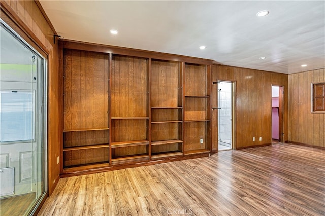 7134 Stansbury Ave, Van Nuys, CA 91405 - empty room with wood finished floors, recessed lighting, and wooden walls