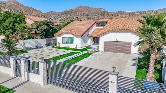 13800 Glenoaks Blvd, Sylmar, CA 91342 - mediterranean / spanish home featuring a fenced front yard, a tiled roof, stucco siding, and a mountain view