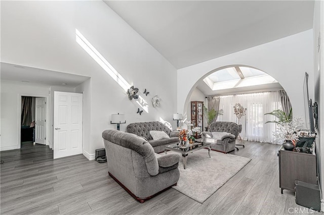 13800 Glenoaks Blvd, Sylmar, CA 91342 - living area with arched walkways, wood finished floors, and high vaulted ceiling