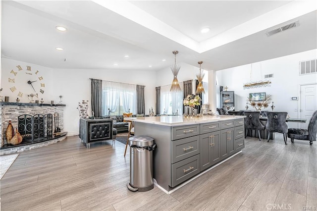 13800 Glenoaks Blvd, Sylmar, CA 91342 - kitchen featuring gray cabinets, open floor plan, light countertops, recessed lighting, and light wood-style floors