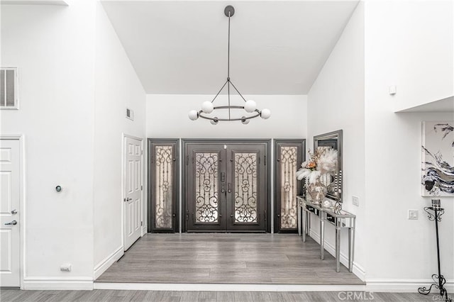 13800 Glenoaks Blvd, Sylmar, CA 91342 - foyer entrance featuring a chandelier, wood finished floors, french doors, and lofted ceiling