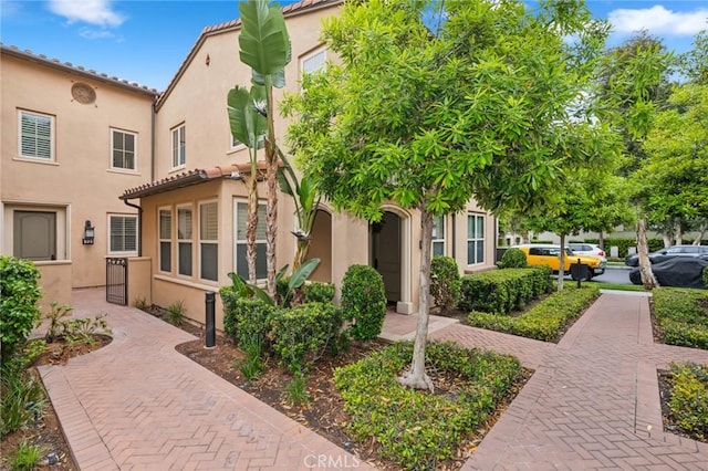 72 Peony, Irvine, CA 92618 - view of front facade with stucco siding and a tile roof