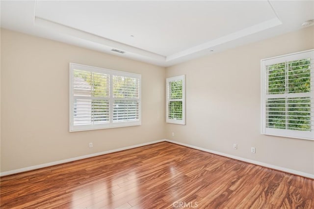 72 Peony, Irvine, CA 92618 - empty room featuring a raised ceiling and wood finished floors
