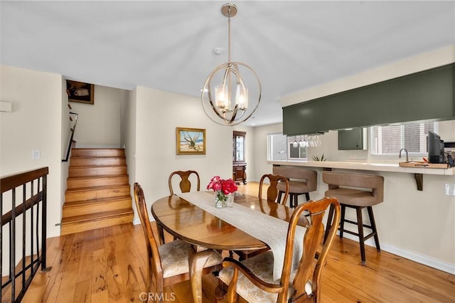 504 Harkness Ln Unit 1, Redondo Beach, CA 90278 - dining area with light wood-style flooring, stairs, and a chandelier