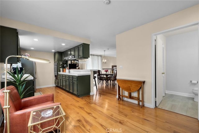 504 Harkness Ln Unit 1, Redondo Beach, CA 90278 - kitchen featuring green cabinets, light wood-style flooring, light countertops, stainless steel oven, and recessed lighting