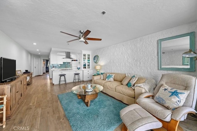 615 Esplanade Unit 504, Redondo Beach, CA 90277 - living room with light wood finished floors, ceiling fan, a textured ceiling, recessed lighting, and a textured wall