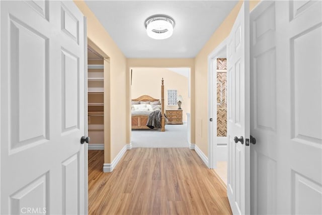 5706 E Bryce Ave, Orange, CA 92867 - corridor with baseboards and light wood-style flooring