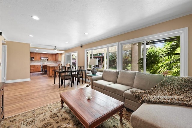 5706 E Bryce Ave, Orange, CA 92867 - living area with recessed lighting, light wood-style floors, a ceiling fan, and crown molding