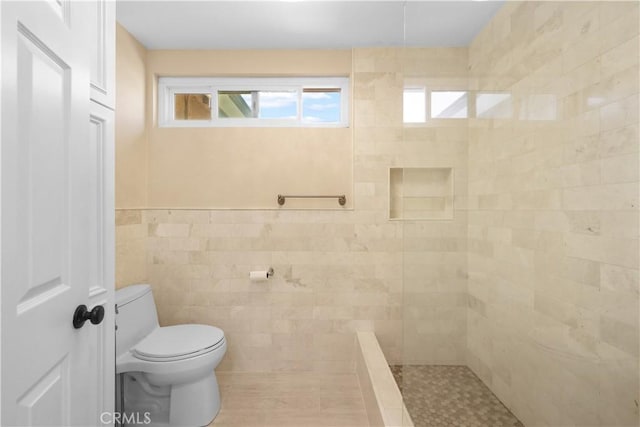 5706 E Bryce Ave, Orange, CA 92867 - full bathroom with tiled shower, tile walls, and wainscoting