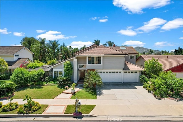 5706 E Bryce Ave, Orange, CA 92867 - view of front of house featuring a tiled roof, a garage, concrete driveway, and a front yard