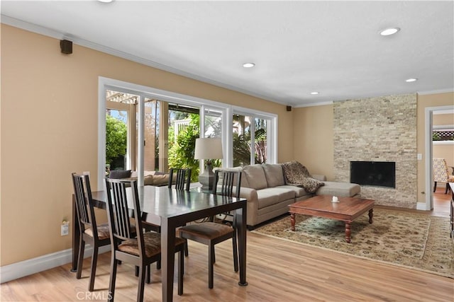 5706 E Bryce Ave, Orange, CA 92867 - living room with crown molding, light wood-style flooring, a fireplace, and recessed lighting