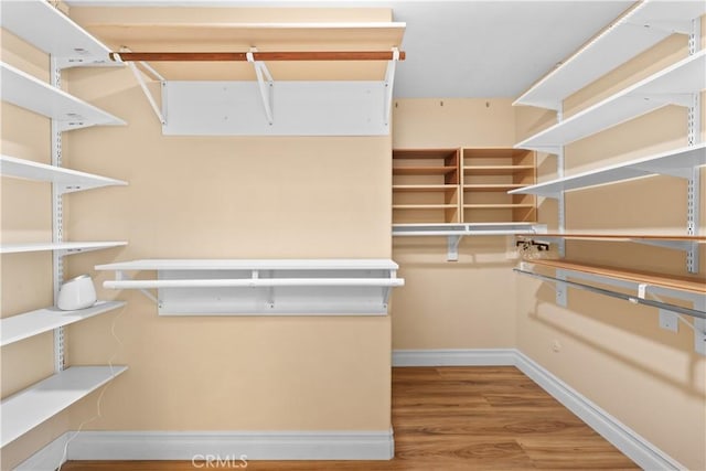 5706 E Bryce Ave, Orange, CA 92867 - walk in closet featuring wood finished floors