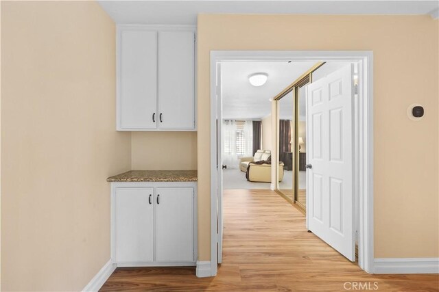 5706 E Bryce Ave, Orange, CA 92867 - hall featuring light wood-style floors and baseboards