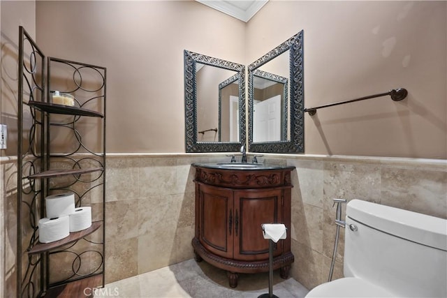 5706 E Bryce Ave, Orange, CA 92867 - bathroom featuring tile walls, ornamental molding, vanity, and wainscoting