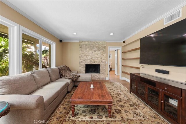 5706 E Bryce Ave, Orange, CA 92867 - living room featuring crown molding, wood finished floors, a stone fireplace, and recessed lighting
