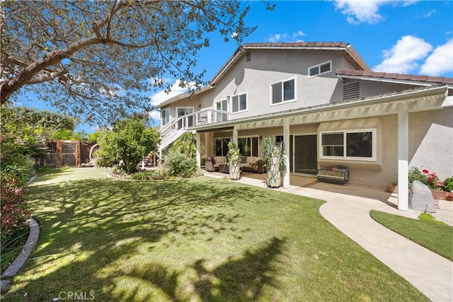 5706 E Bryce Ave, Orange, CA 92867 - back of property featuring stucco siding, an outdoor hangout area, a patio, and stairs