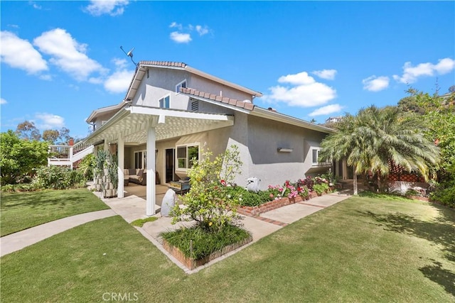 5706 E Bryce Ave, Orange, CA 92867 - rear view of house featuring a patio area, stucco siding, a lawn, and an outdoor living space